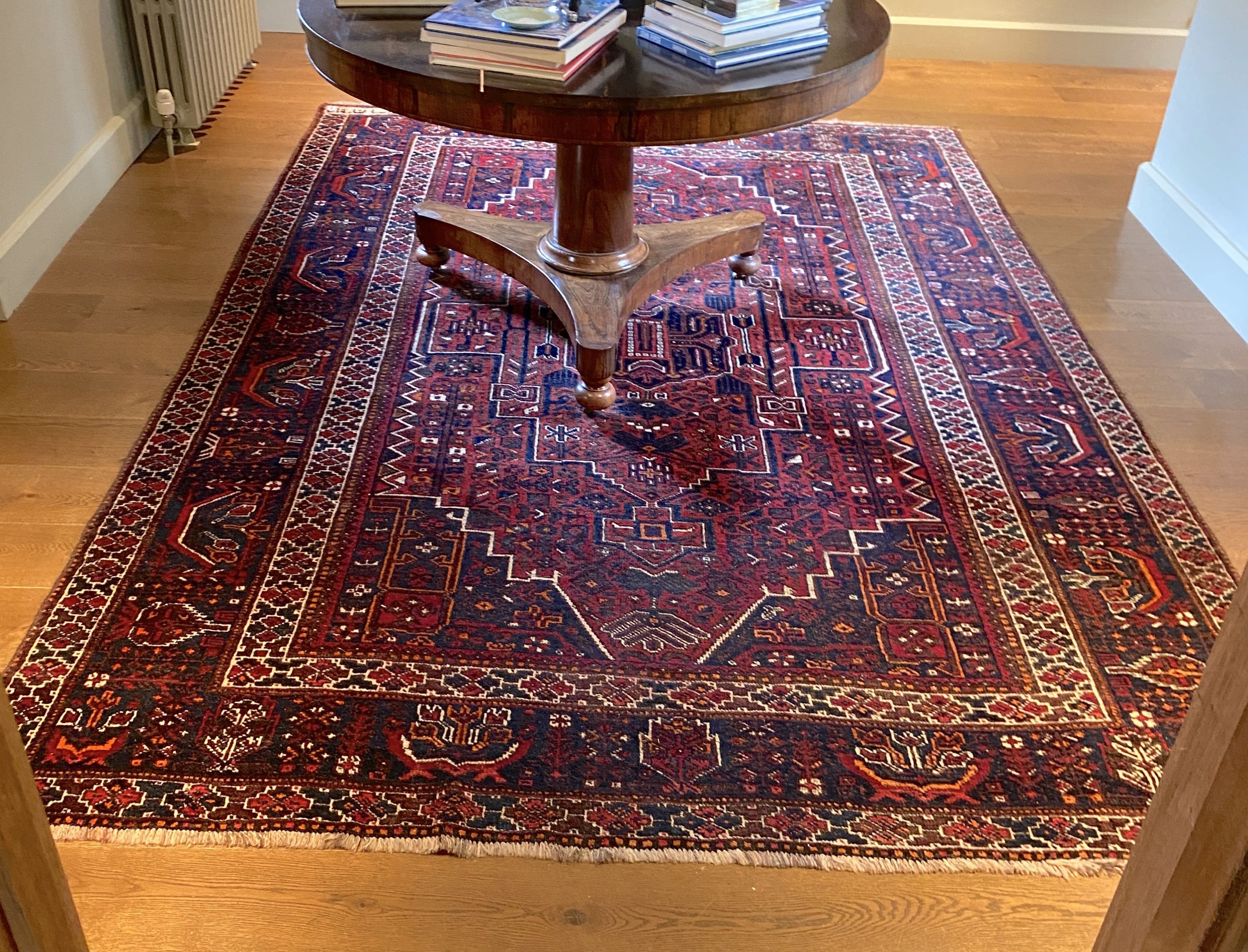 A Caucasian red ground carpet, decorated with foliate motifs, multi-bordered and signed in one corner, 300 x 208cm